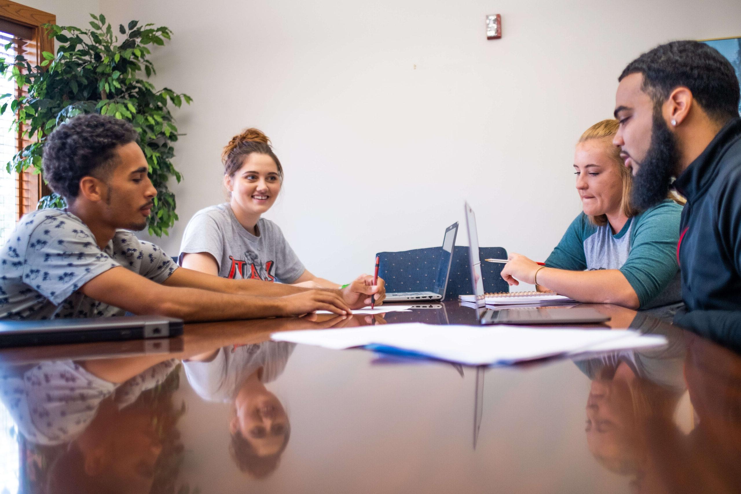 four college students at a table